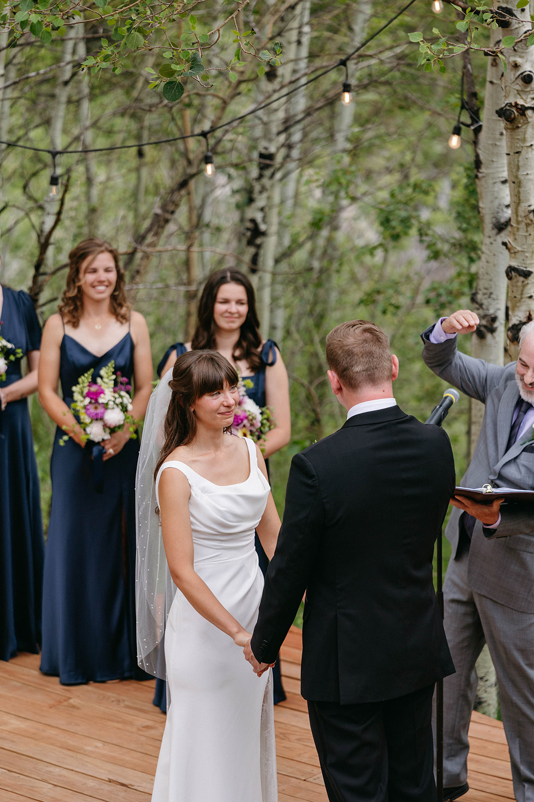 Jason and Amy kissing on the rocks framed by aspen trees